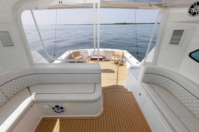 Slide: The Image of 2023 Henriques 42 Express Hardtop boat interior with seating and ocean view. - 41