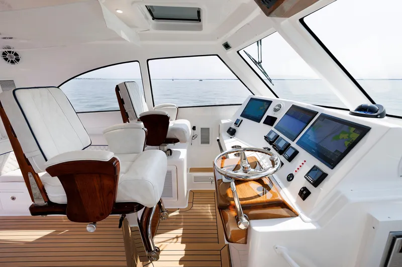 Slide: The Image of 2023 Henriques 42 Express Hardtop helm with dual seats and advanced navigation displays. - 43