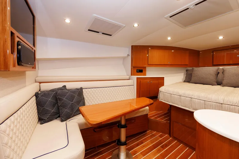 Slide: The Image of 2023 Henriques 42 Express Hardtop interior with cozy seating and elegant wood finishes. - 50