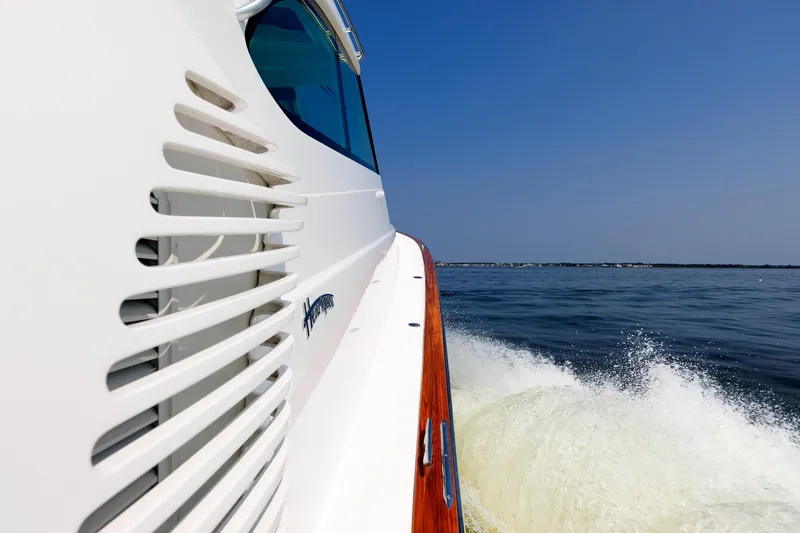 Slide: The Image of 2023 Henriques 42 Express Hardtop cruising on open water, side view. - 61
