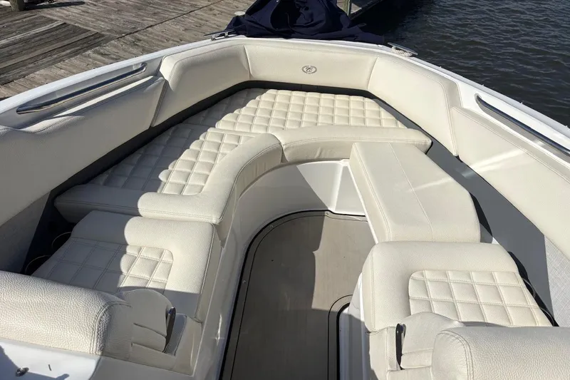 Slide: The Image of Luxurious seating area on a 2019 Cobalt R5 boat, featuring quilted white upholstery. - 19