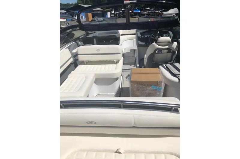 Slide: The Image of 2019 Cobalt R5 boat interior with white seating and a cardboard box. - 2