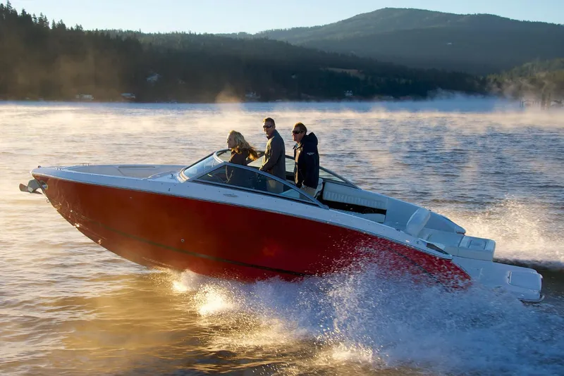 Slide: The Image of Manufacturer Provided Image: 2019 Cobalt R5 boat cruising on a lake with passengers, scenic mountain background. - 3