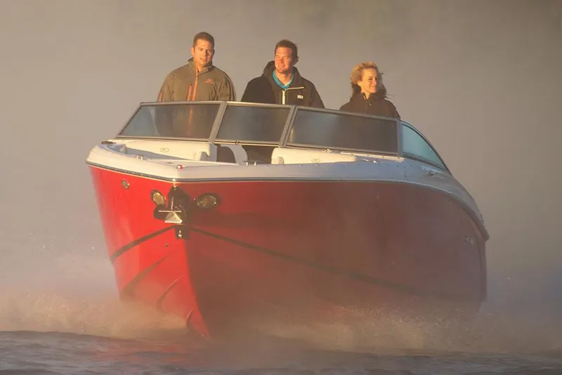 Slide: The Image of Manufacturer Provided Image: 2019 Cobalt R5 boat with three people cruising on water. - 9