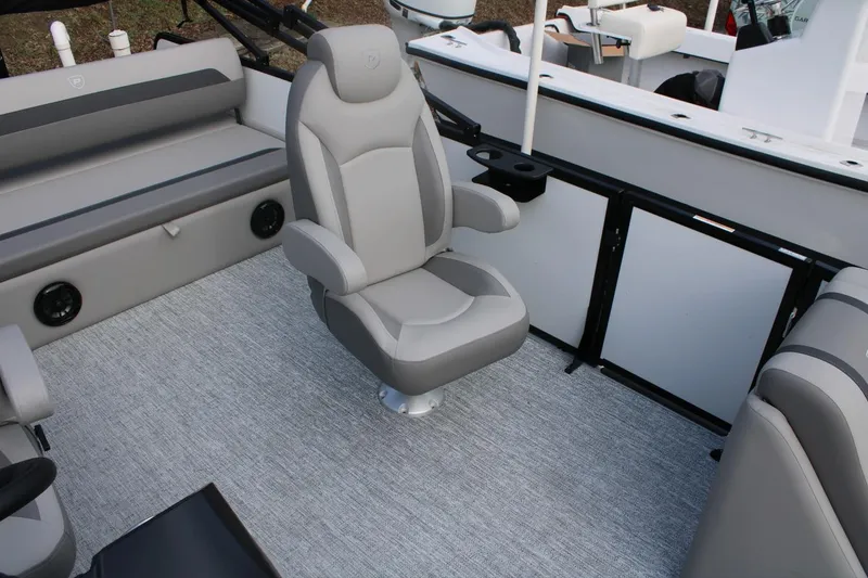 Slide: The Image of 2026 Premier 220 Sunscape RL - CL boat interior with gray seating and carpet flooring. - 11