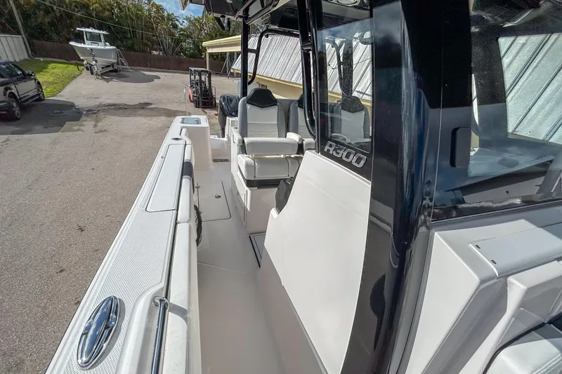 Slide: The Image of 2025 Robalo R300 Center Console boat, sleek design, spacious deck, modern features. - 13