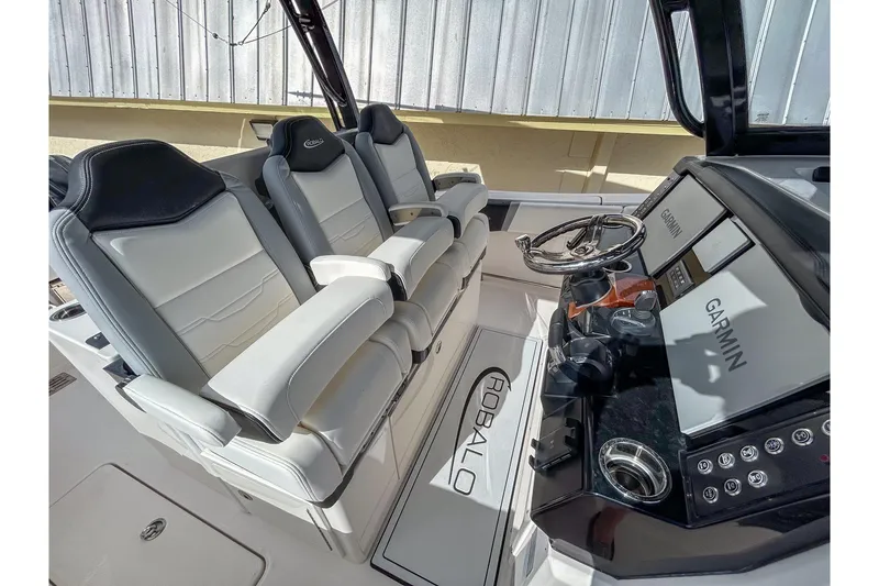 Slide: The Image of 2025 Robalo R300 Center Console interior with Garmin displays and luxury seating. - 3