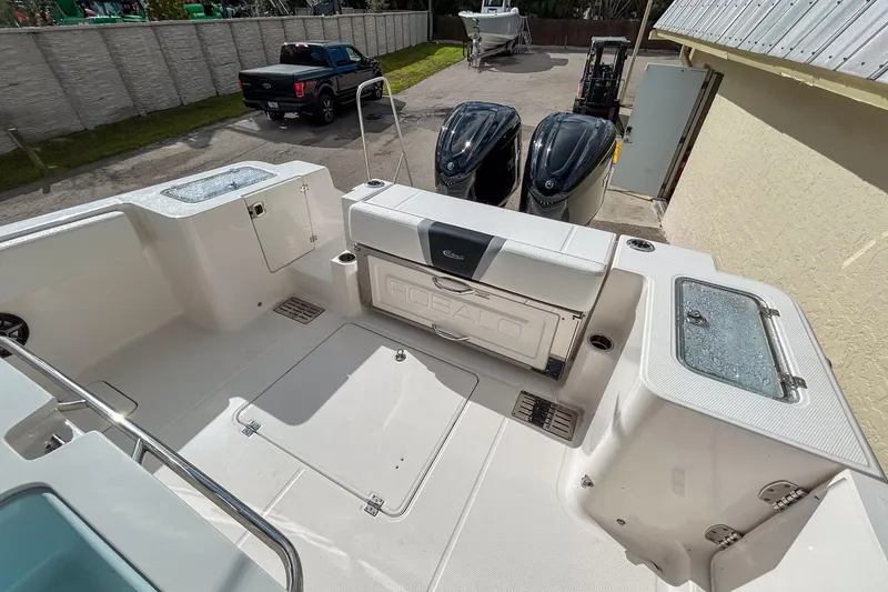 Slide: The Image of 2025 Robalo R300 Center Console boat deck with dual outboard engines. - 6