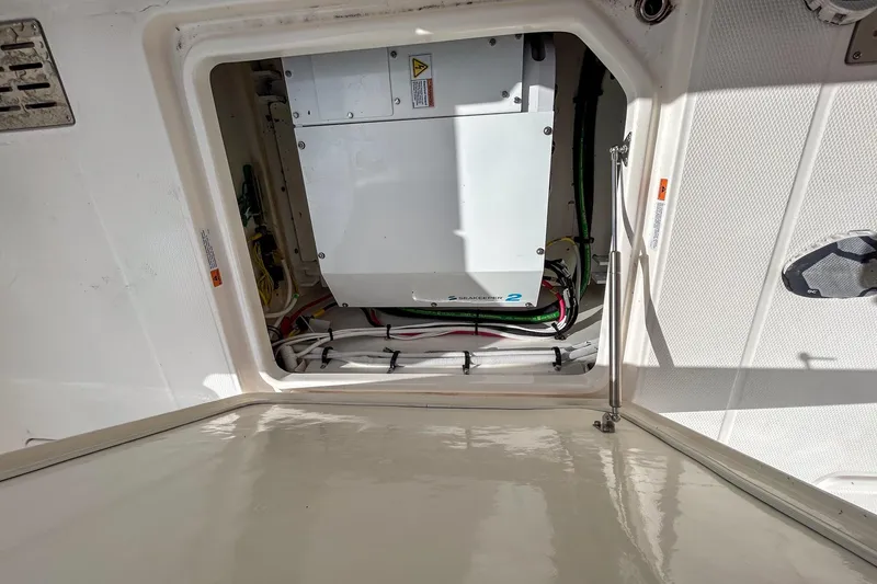 Slide: The Image of 2025 Robalo R300 Center Console boat interior with visible wiring and equipment. - 7