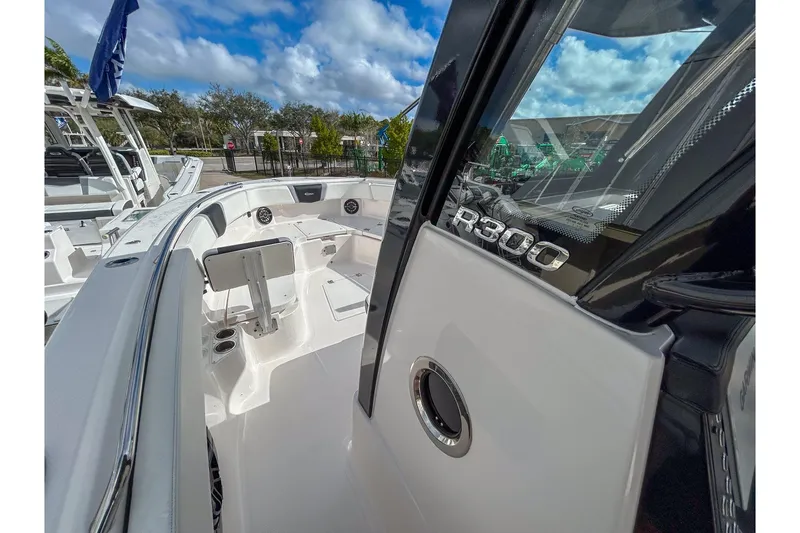 Slide: The Image of 2025 Robalo R300 Center Console boat with sleek design and spacious deck. - 9