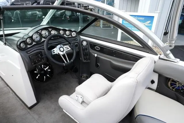 Slide: The Image of 2006 Supra Launch 20 SSV boat interior with steering wheel and dashboard controls. - 12