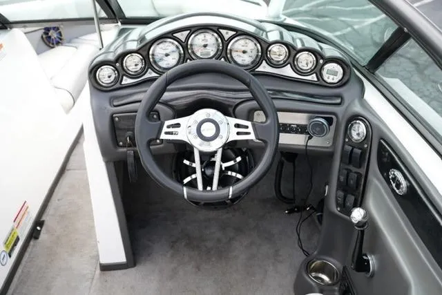 Slide: The Image of 2006 Supra Launch 20 SSV boat dashboard with steering wheel and gauges. - 13