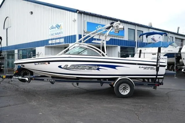 Slide: The Image of 2006 Supra Launch 20 SSV boat on trailer outside dealership. - 21
