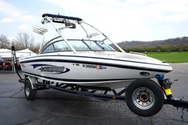 Slide: The Image of 2006 Supra Launch 20 SSV boat on trailer, parked outdoors. - 23