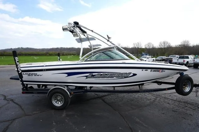 Slide: The Image of 2006 Supra Launch 20 SSV boat on trailer, parked outdoors. - 24