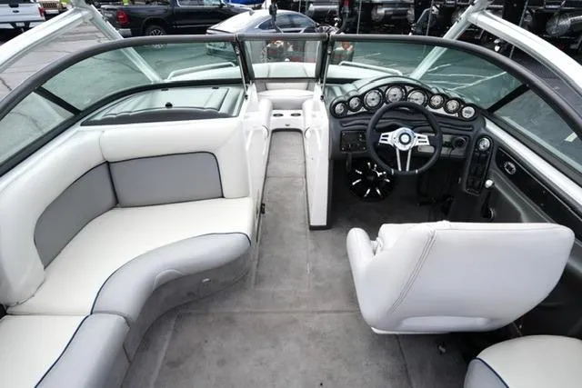 Slide: The Image of 2006 Supra Launch 20 SSV boat interior with white seating and modern dashboard. - 31