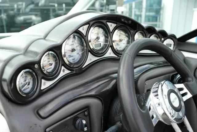 Slide: The Image of Dashboard of a 2006 Supra Launch 20 SSV boat with multiple gauges and steering wheel. - 34