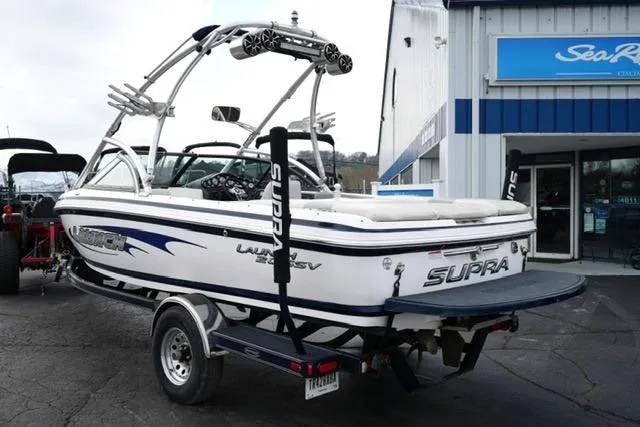 Slide: The Image of 2006 Supra Launch 20 SSV boat on trailer outside dealership. - 6