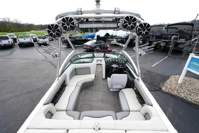 Slide: The Image of 2006 Supra Launch 20 SSV boat with spacious seating and advanced audio system in a parking lot. - 7