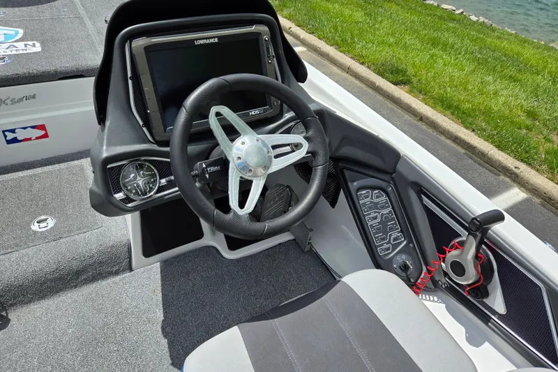 Slide: The Image of 2015 Skeeter FX20 boat cockpit with steering wheel and control panel. - 13