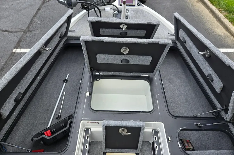 Slide: The Image of 2015 Skeeter FX20 boat with open storage compartments and fishing gear. - 15