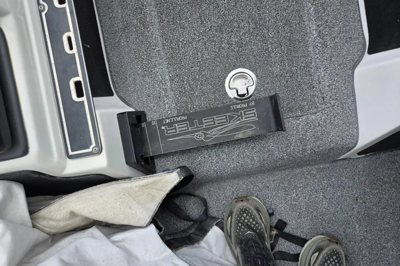 Slide: The Image of 2015 Skeeter FX20 boat interior with measuring tool and carpeted floor. - 17