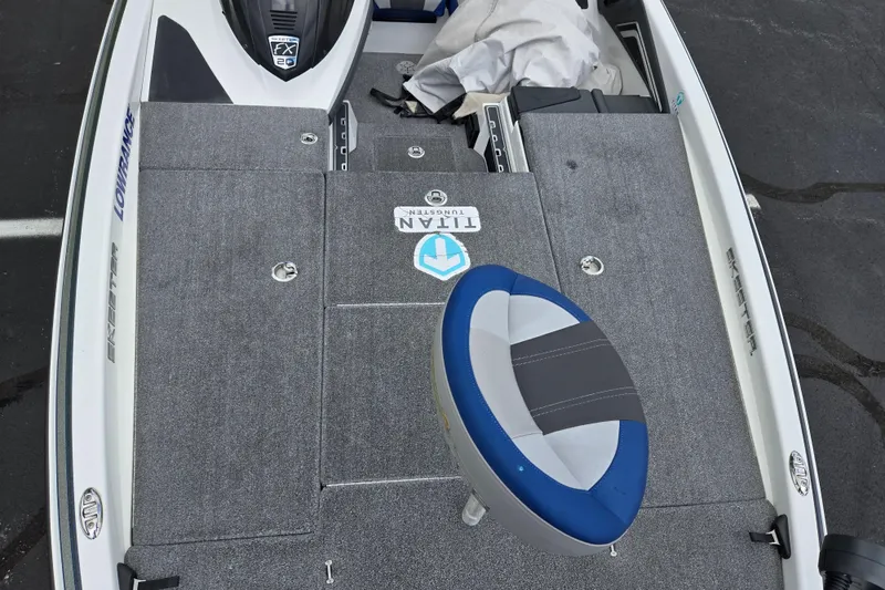 Slide: The Image of 2015 Skeeter FX20 boat deck with gray carpet and blue seat. - 20