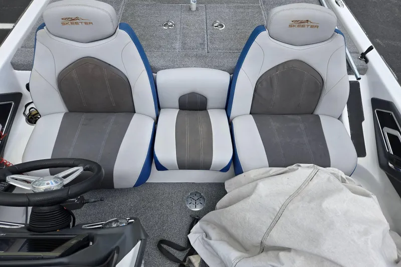 Slide: The Image of 2015 Skeeter FX20 boat interior with dual seats and steering wheel. - 22