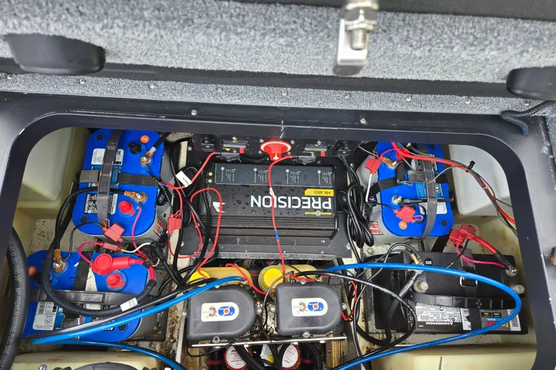 Slide: The Image of 2015 Skeeter FX20 boat battery compartment with wiring and charger setup. - 26