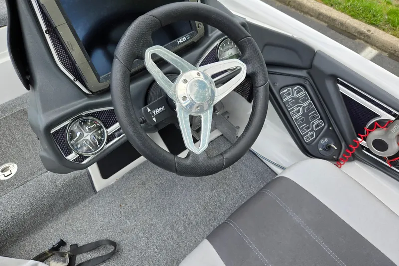 Slide: The Image of 2015 Skeeter FX20 boat dashboard with steering wheel and control panel. - 29