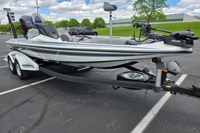 Slide: The Image of 2015 Skeeter FX20 boat on trailer in parking lot, featuring Lowrance equipment. - 5
