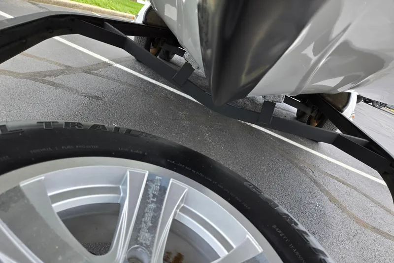 Slide: The Image of 2015 Skeeter FX20 boat on trailer, close-up of hull and wheel in parking lot. - 7