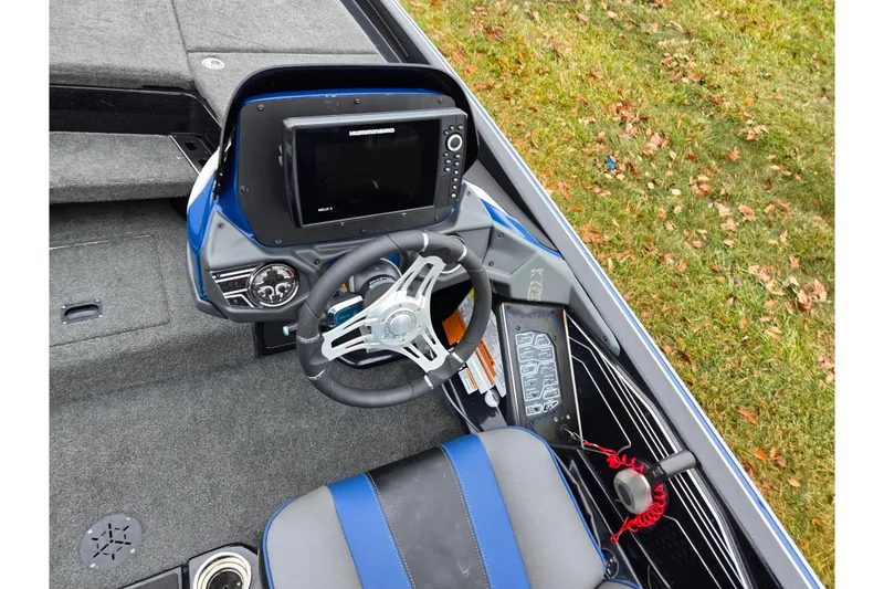 Slide: The Image of 2021 Skeeter FXR20 boat cockpit with steering wheel and navigation system. - 18