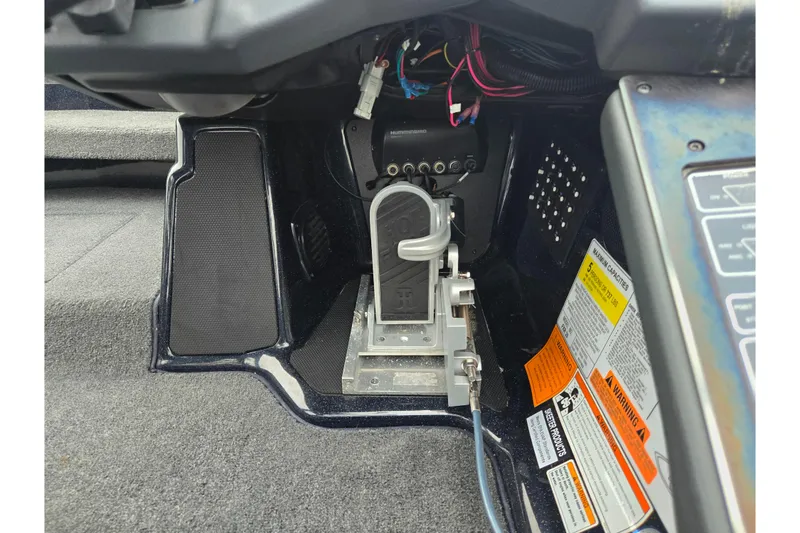 Slide: The Image of 2021 Skeeter FXR20 boat foot pedal and control panel with warning labels. - 19