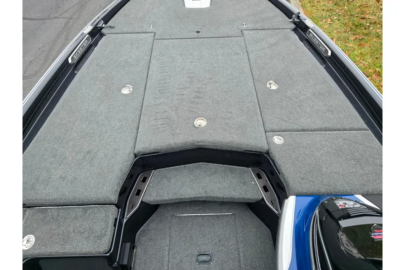 Slide: The Image of 2021 Skeeter FXR20 boat deck with gray carpet and storage compartments. - 21