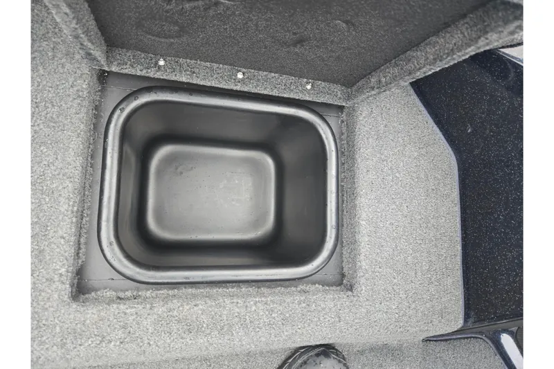 Slide: The Image of 2021 Skeeter FXR20 boat storage compartment with open lid, showcasing interior space. - 22