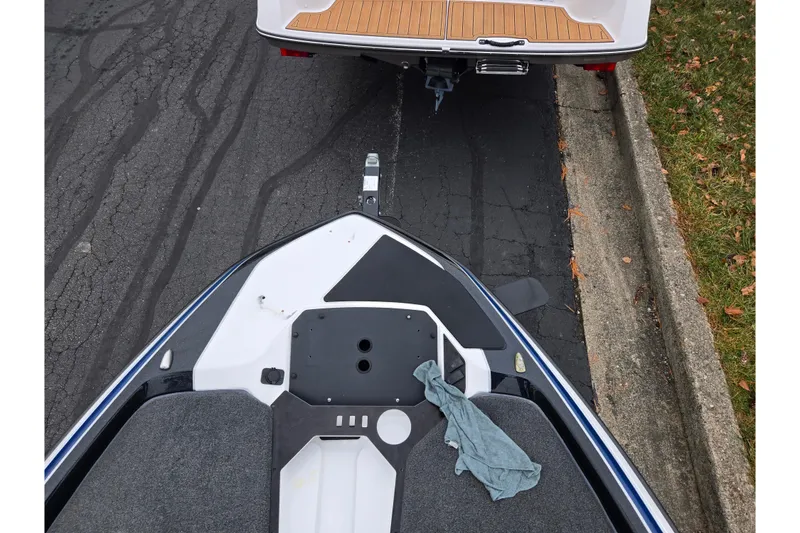 Slide: The Image of 2021 Skeeter FXR20 boat on trailer, parked on asphalt road. - 26