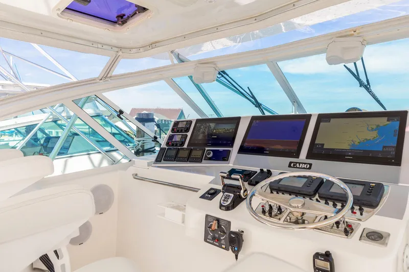 Slide: The Image of 2004 Cabo 40 Express helm with modern navigation equipment and panoramic ocean view. - 14