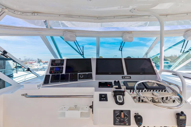 Slide: The Image of Helm of 2004 Cabo 40 Express boat with navigation equipment and steering wheel. - 18