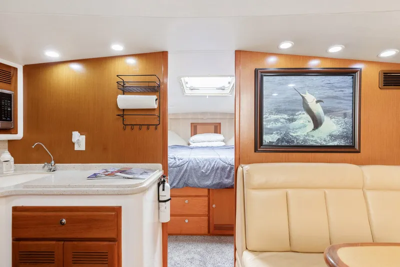 Slide: The Image of Interior of 2004 Cabo 40 Express yacht with cozy seating and elegant wood finishes. - 23