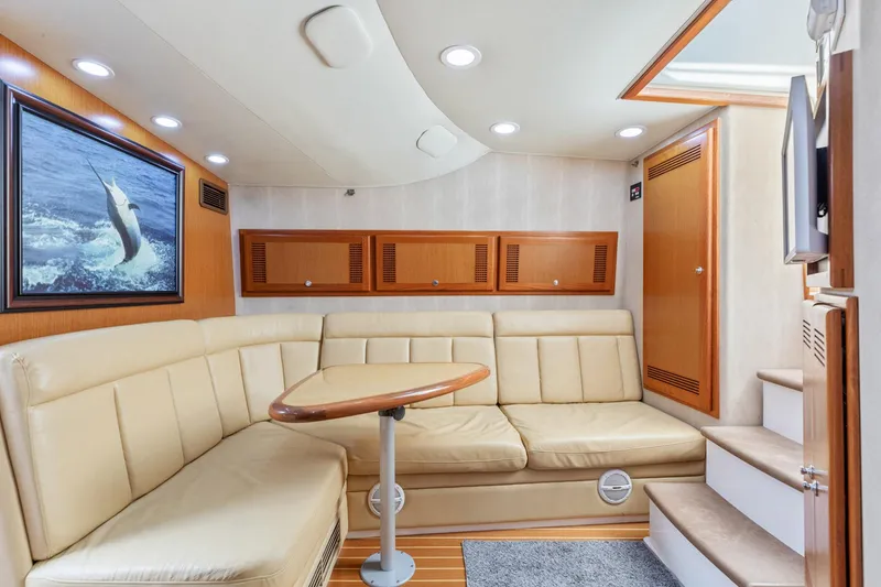 Slide: The Image of Interior of 2004 Cabo 40 Express yacht with beige seating and wooden accents. - 24