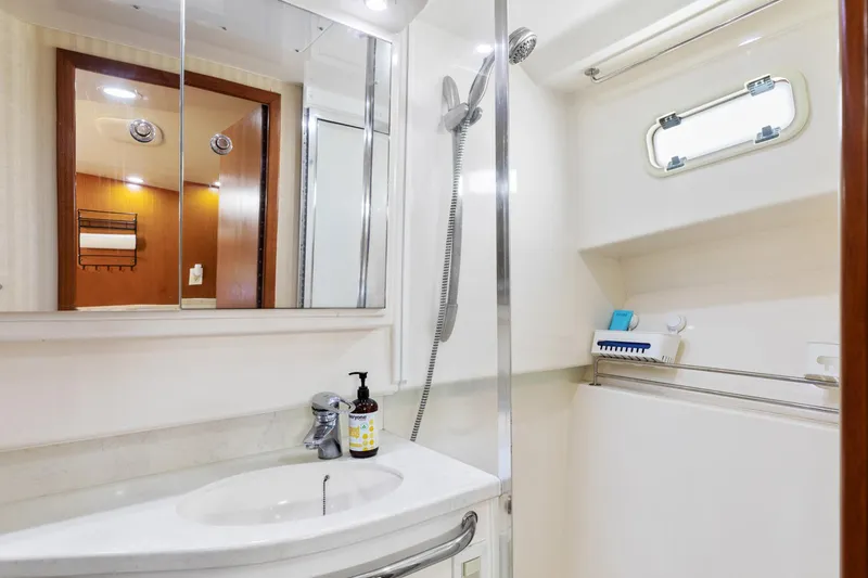 Slide: The Image of Luxurious bathroom in 2004 Cabo 40 Express yacht with modern fixtures and sleek design. - 27