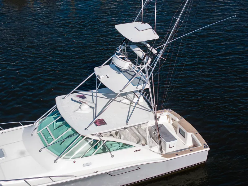 Slide: The Image of 2004 Cabo 40 Express boat with tower on calm water. - 9