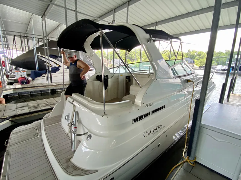 Slide: The Image of 1999 Cruisers Yachts 2870 Express docked under a covered marina. - 21
