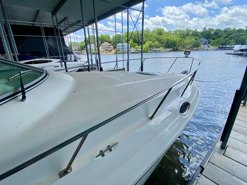 Slide: The Image of 1999 Cruisers Yachts 2870 Express docked, showcasing sleek design and waterfront setting. - 22