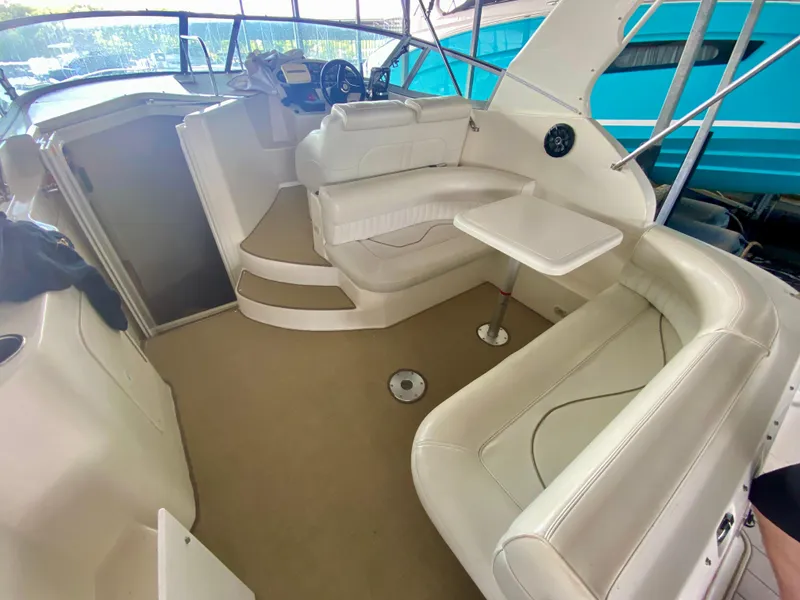 Slide: The Image of 1999 Cruisers Yachts 2870 Express interior with white seating and table. - 4