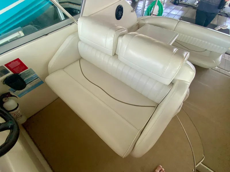 Slide: The Image of 1999 Cruisers Yachts 2870 Express interior with white leather seating and table. - 6