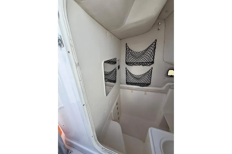 Slide: The Image of Century 3200 Center Console 2000 boat on trailer beside house. - 10