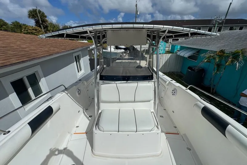 Slide: The Image of 2000 Century 3200 Center Console boat with seating, docked near residential area. - 101