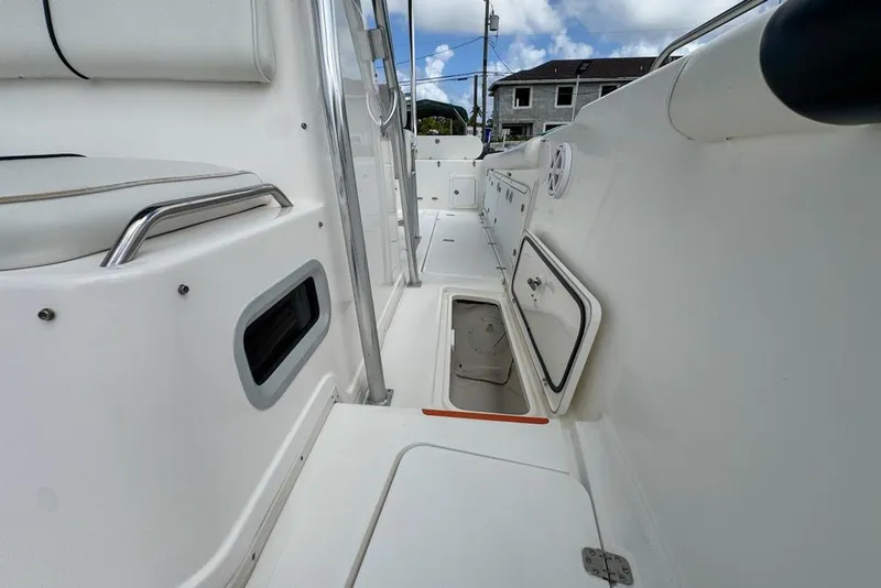 Slide: The Image of Century 3200 Center Console 2000 boat interior with open storage compartments. - 105